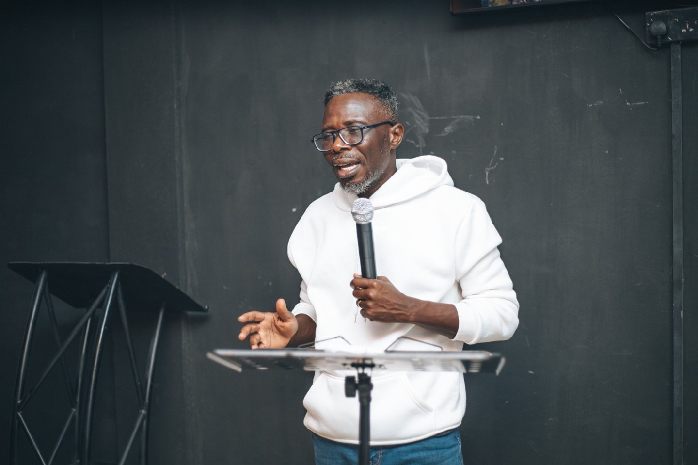 Bernard teaching at a lectern during a personal development session